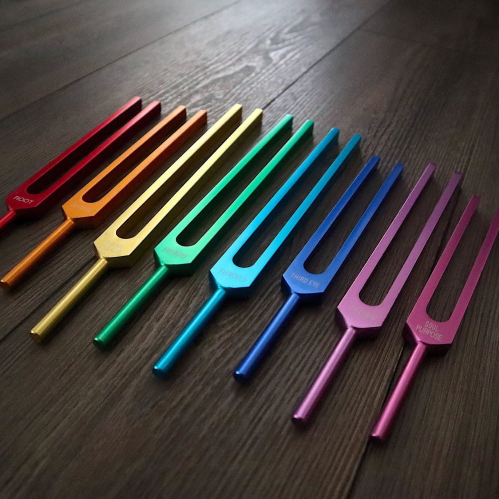 Rainbow-colored tuning forks in spectrum for Chakra healing therapy set