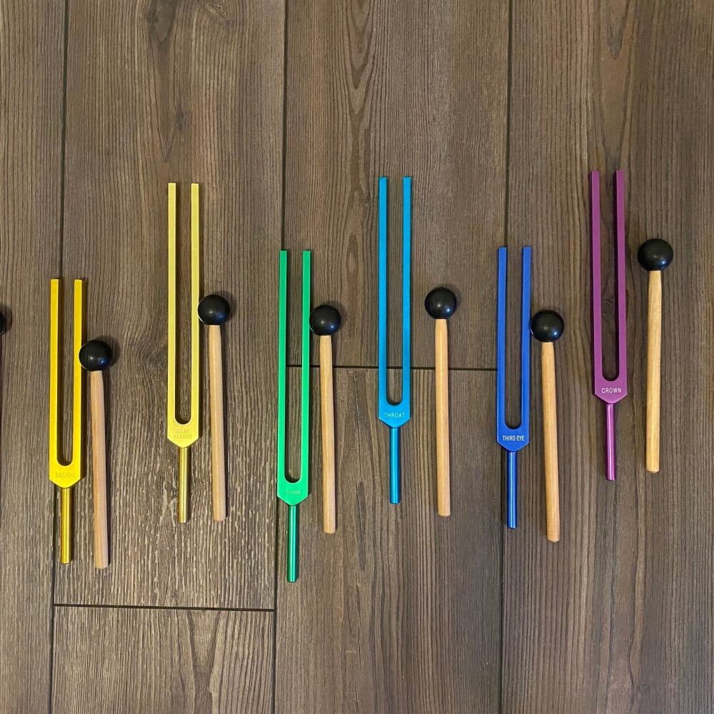 Colorful tuning forks in a row from the 8pc Chakra Tuning Fork Set for Healing