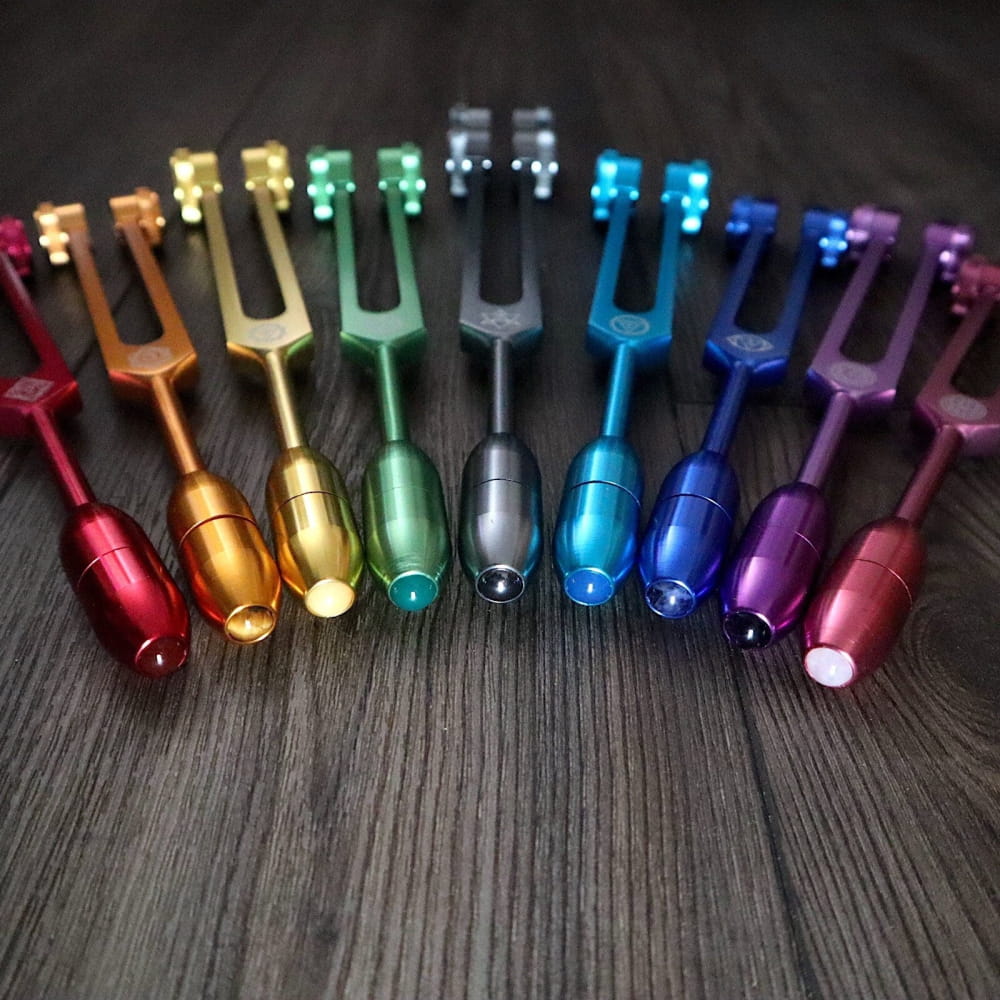 Rainbow-colored tuning forks in a semicircle for Chakra healing and sound therapy