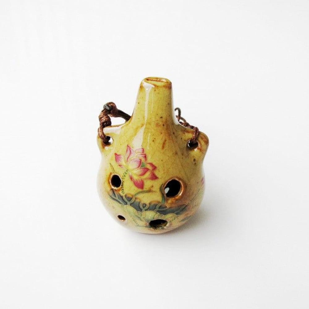 Yellow ceramic vase with floral designs and multiple holes for decoration