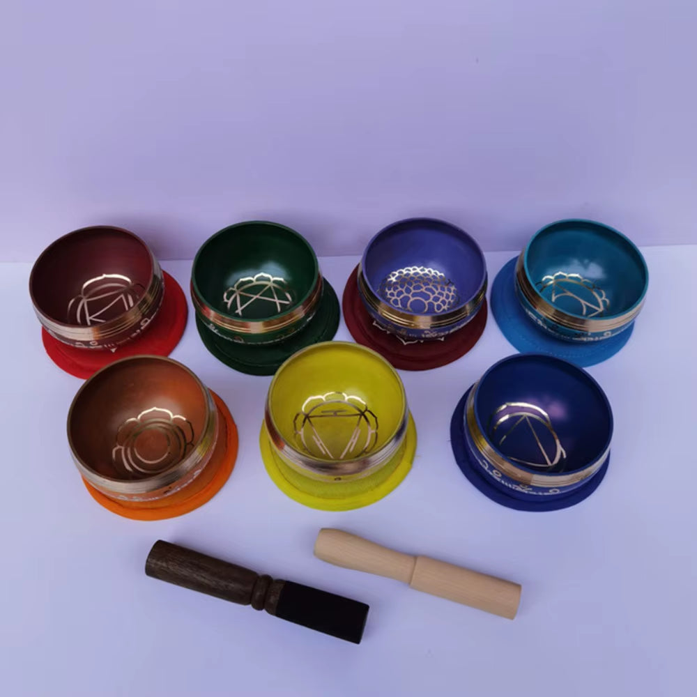 Seven colorful Brass Tibetan Singing Bowls in a circular pattern for meditation