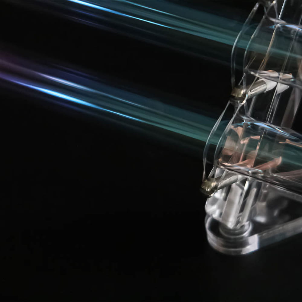 Glass test tube with glowing blue-green streaks in Colorful Quartz Crystal Harp 440/432Hz