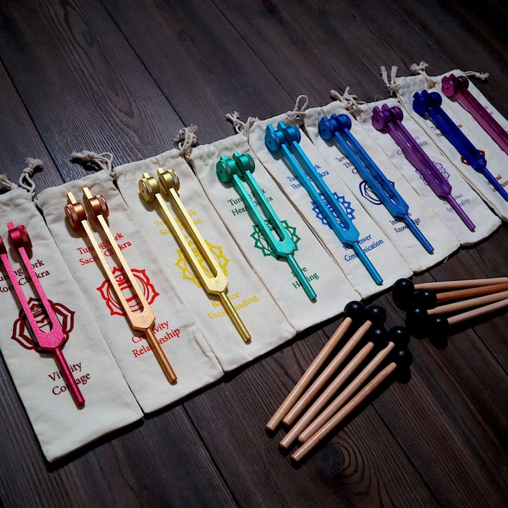 Colorful metallic tuning forks in rainbow sequence, part of Solfeggio Tuning Fork Set