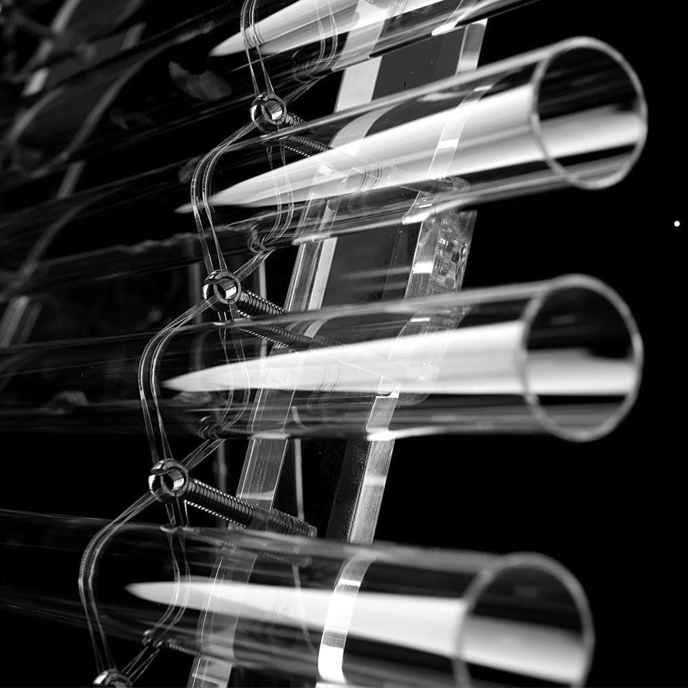 Metallic fluorescent light tubes in parallel rows for Crystal Quartz Singing Harp