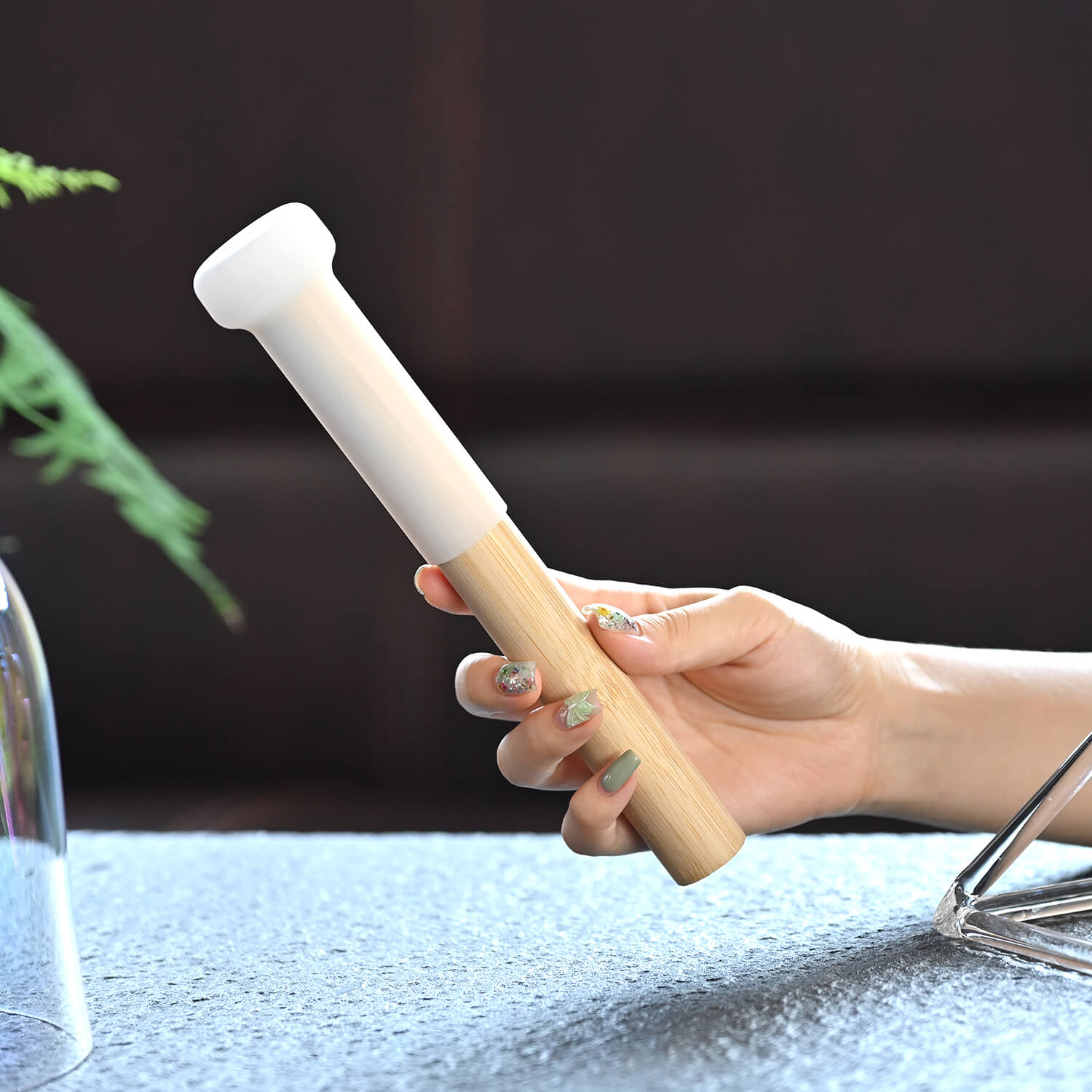 White ceramic mortar and pestle held with green nail polish next to Crystal Singing Bowl Magic Mallet