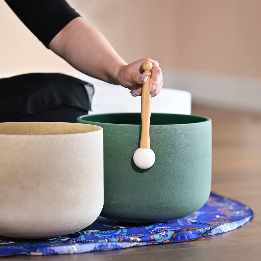 Ceramic bowls in white and green with a wooden spoon for F
