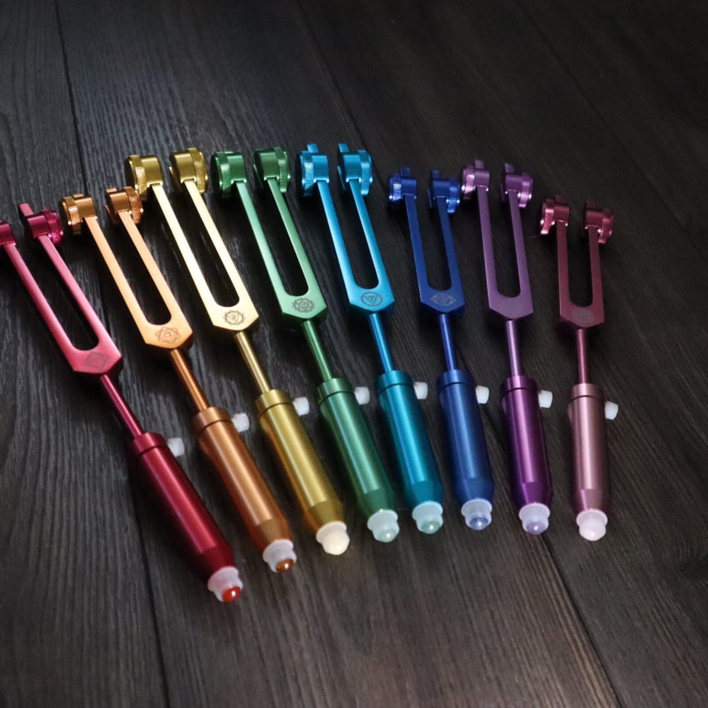 Rainbow-colored Gemstone Aromatherapy Tuning Forks arranged in a vibrant spectrum