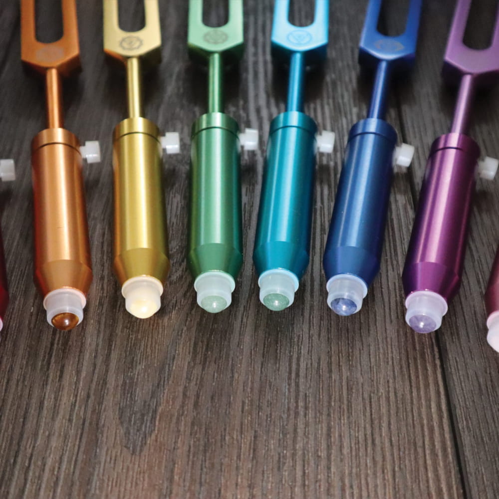 Colorful metallic tuning forks in rainbow sequence for Gemstone Aromatherapy
