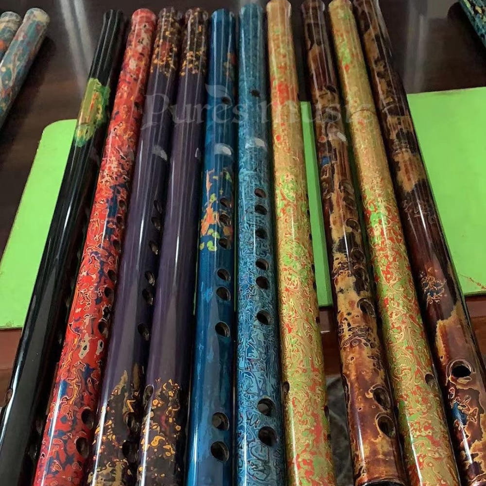 Colorful hand-painted bamboo flutes with decorative patterns, ideal for collectors