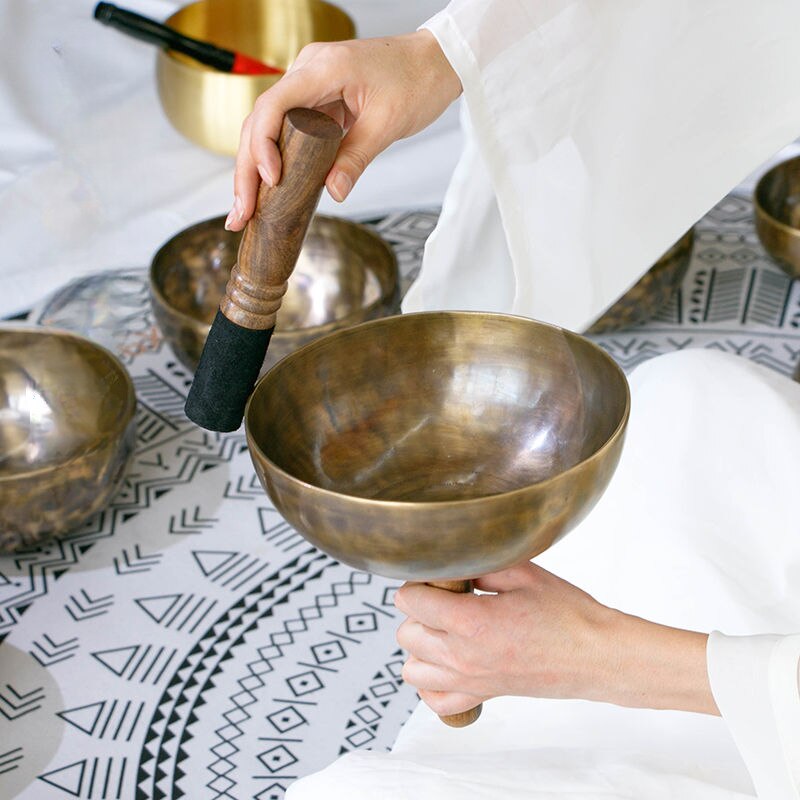 Tibetan Singing Bowl played with wooden mallet in Nepal Handmade Meditation Bell Instrument