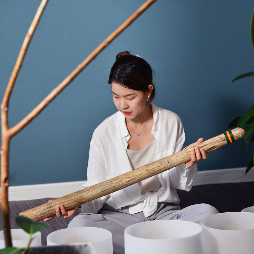 Bamboo stick held horizontally showcasing 40 inch Handcrafted Rainstick for meditation