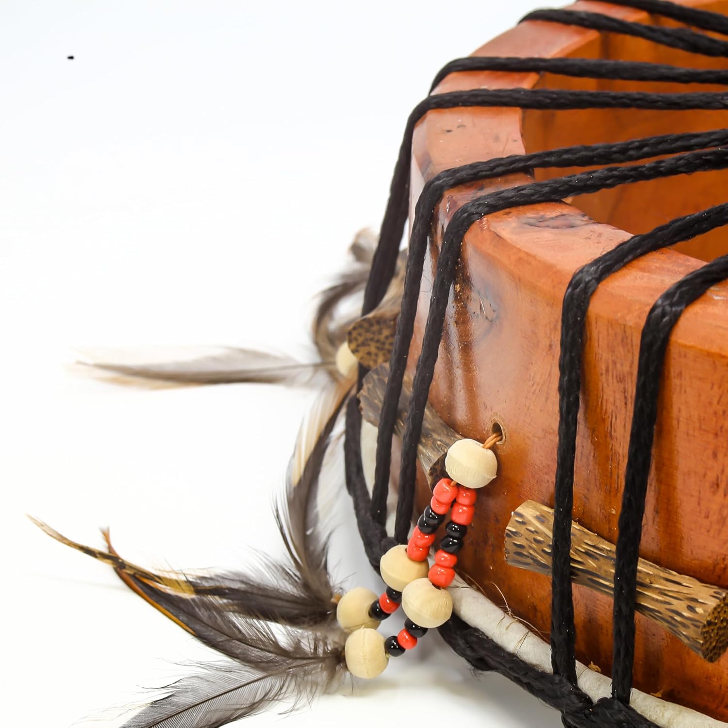 Orange cake with black stripes and feather accents on Shamanic Hand Drum display